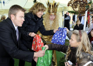 Tierheim-Präsidentin Dagmar Wöhrl, das Christkind und Markus König, Vorsitzender des Tierschutzvereins beschenken die Kinder bei der Waldweihnacht. 